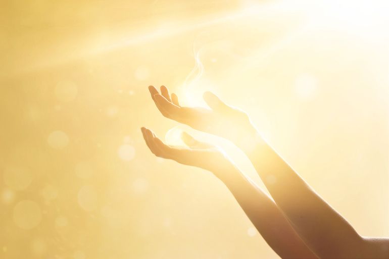 Woman hand praying for blessing from god on sunset background