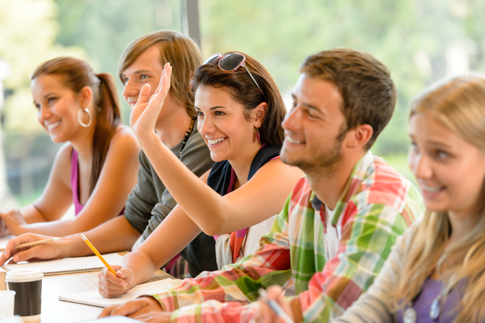 Happy adult students in a classroom 