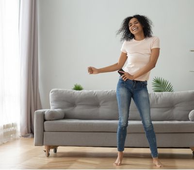 happy african American young woman have fun enjoying listening to music, entertain on weekend at home