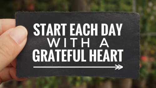 Motivational and inspirational quote - ‘Start each day with a grateful heart’ written on a paper.