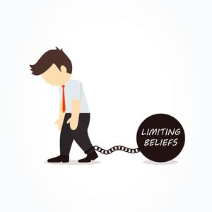 Businessman chained to his limiting beliefs