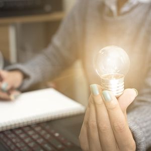 Business women hand holding light bulb, concept of new ideas with innovation and creativity.